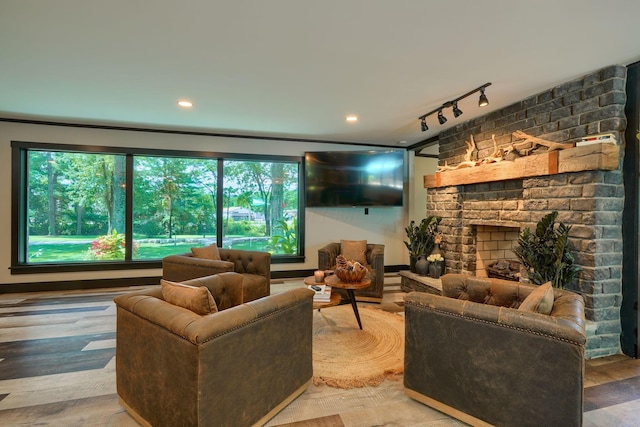 1300 Dannie Dr, Logan, OH 43138 - living area featuring a fireplace, track lighting, and wood finished floors