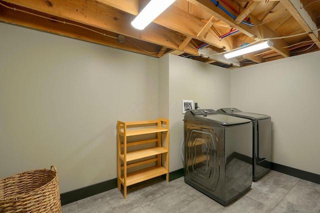 1300 Dannie Dr, Logan, OH 43138 - laundry room featuring washing machine and clothes dryer and baseboards