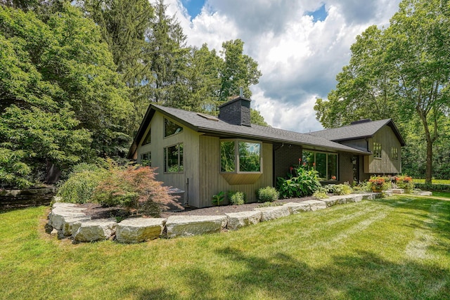 1300 Dannie Dr, Logan, OH 43138 - view of front of home featuring a chimney and a front yard
