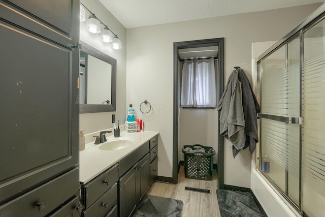 1300 Dannie Dr, Logan, OH 43138 - full bathroom featuring wood finished floors, vanity, and enclosed tub / shower combo