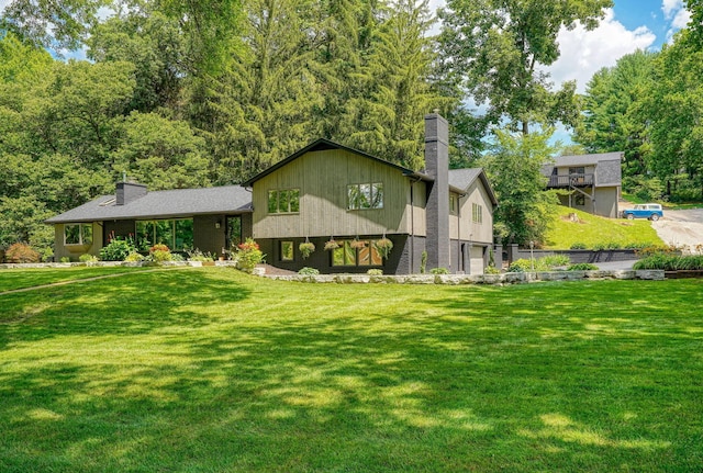 1300 Dannie Dr, Logan, OH 43138 - tri-level home featuring a chimney, a front yard, and an attached garage