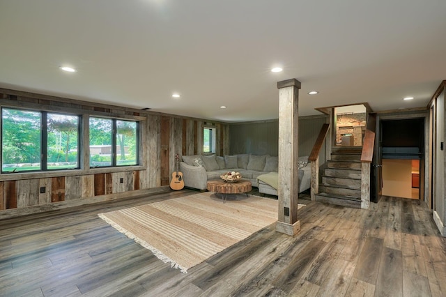 1300 Dannie Dr, Logan, OH 43138 - living room with stairway, wood finished floors, wooden walls, and recessed lighting