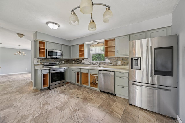 330 Tralee Trl, Cardington, OH 43315 - kitchen with appliances with stainless steel finishes, open shelves, a chandelier, and light countertops