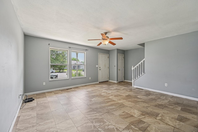 330 Tralee Trl, Cardington, OH 43315 - unfurnished room featuring ceiling fan, stairway, and a textured ceiling