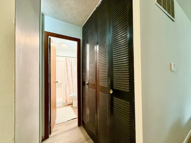 3811 Bradford Dr, Hilliard, OH 43026 - hall featuring light wood-type flooring and a textured ceiling