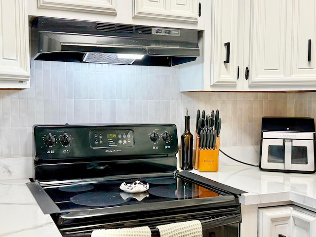 3811 Bradford Dr, Hilliard, OH 43026 - kitchen with black electric range, under cabinet range hood, white cabinets, and backsplash