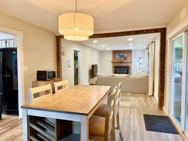3811 Bradford Dr, Hilliard, OH 43026 - dining area with light wood-style flooring, a fireplace, and recessed lighting