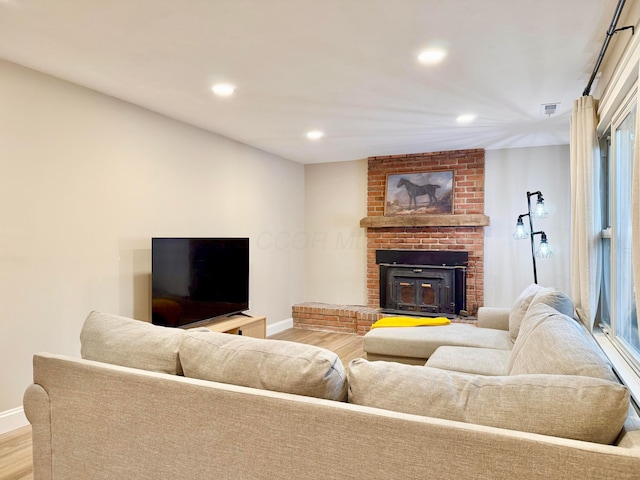 3811 Bradford Dr, Hilliard, OH 43026 - living room featuring wood finished floors, recessed lighting, and a fireplace