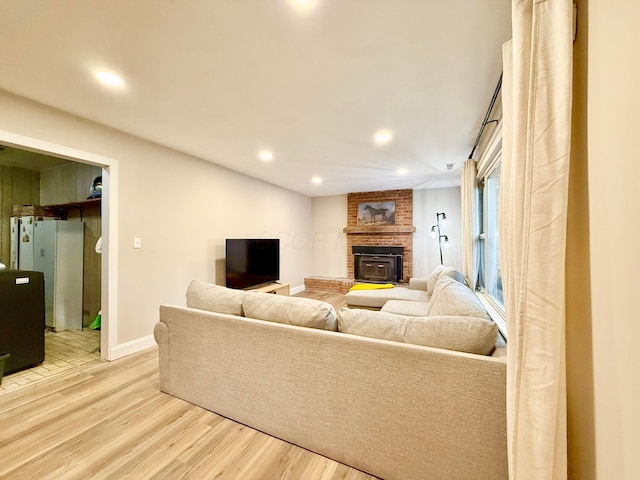 3811 Bradford Dr, Hilliard, OH 43026 - living room featuring light wood-style floors, recessed lighting, and a fireplace