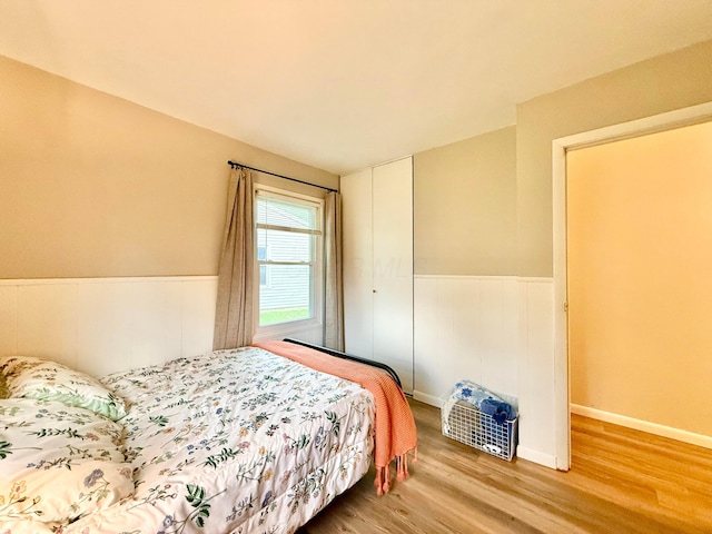 3811 Bradford Dr, Hilliard, OH 43026 - bedroom with light wood-type flooring, a closet, and a wainscoted wall