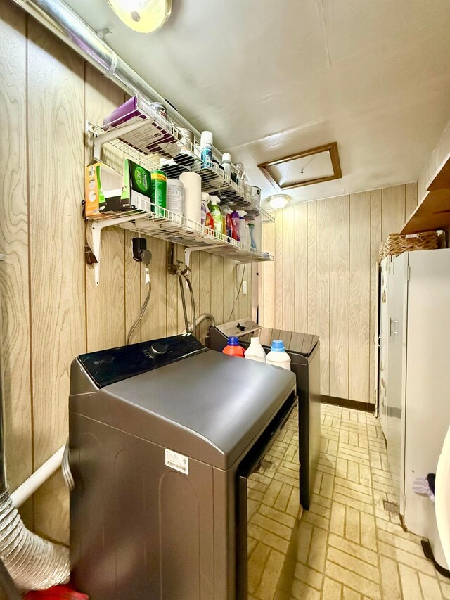 3811 Bradford Dr, Hilliard, OH 43026 - laundry area featuring brick patterned flooring, wooden walls, and independent washer and dryer