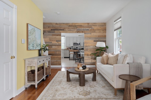 251 Detroit Ave, Columbus, OH 43201 - living area featuring wooden walls, wood finished floors, and an accent wall