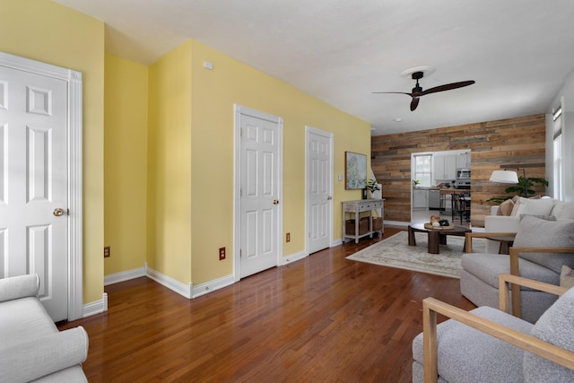 251 Detroit Ave, Columbus, OH 43201 - living area with wooden walls, an accent wall, a ceiling fan, and wood finished floors