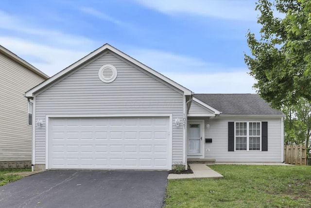 1021 Lavender Ln, Columbus, OH 43207 - ranch-style house featuring asphalt driveway and an attached garage