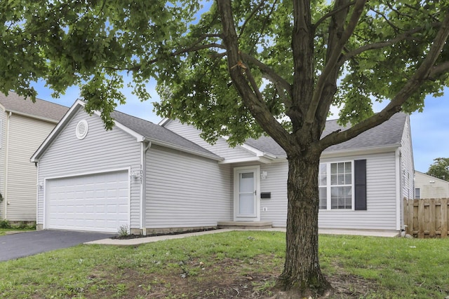 1021 Lavender Ln, Columbus, OH 43207 - ranch-style house featuring asphalt driveway and an attached garage