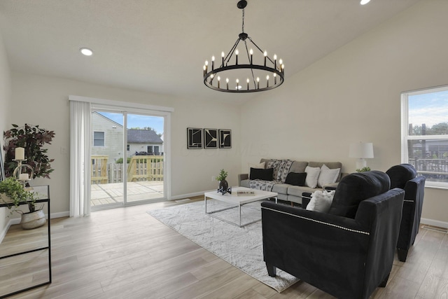1021 Lavender Ln, Columbus, OH 43207 - living room with a chandelier, recessed lighting, light wood-style floors, and vaulted ceiling