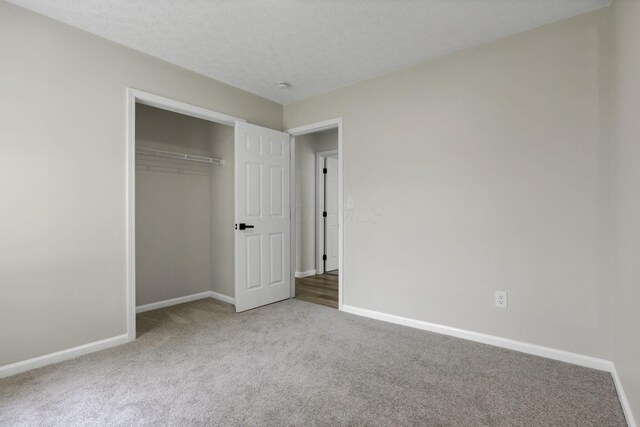 1021 Lavender Ln, Columbus, OH 43207 - unfurnished bedroom featuring carpet flooring, a closet, and a textured ceiling