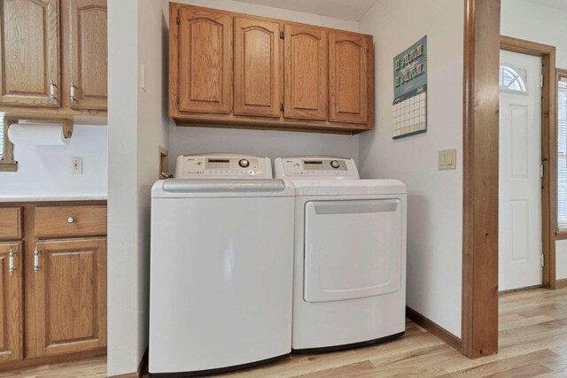 6658 Ridpath Rd, Grove City, OH 43123 - washroom with separate washer and dryer, cabinet space, and light wood finished floors