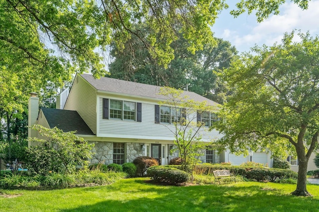 1318 Hickory Ridge Ln, Columbus, OH 43235 - colonial home with stone siding, a front yard, a chimney, and an attached garage