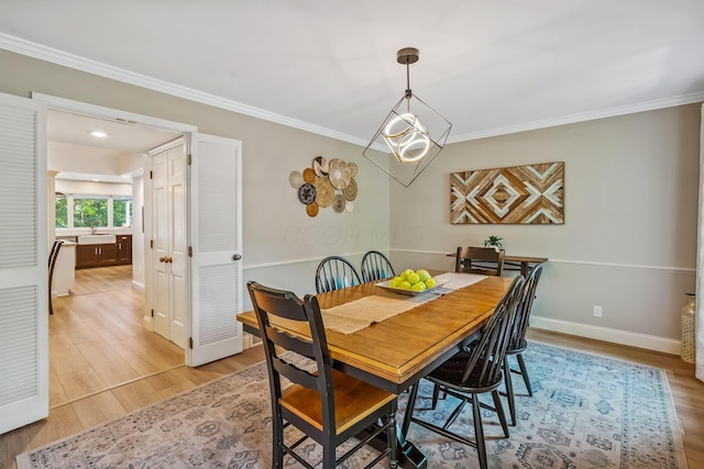 1318 Hickory Ridge Ln, Columbus, OH 43235 - dining area with light wood-style flooring and ornamental molding
