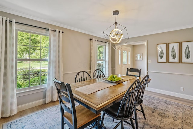 1318 Hickory Ridge Ln, Columbus, OH 43235 - dining area featuring light wood-style flooring, a chandelier, and crown molding