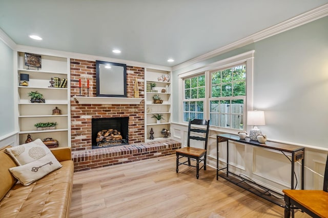 1318 Hickory Ridge Ln, Columbus, OH 43235 - living area with crown molding, wood finished floors, a brick fireplace, built in shelves, and recessed lighting