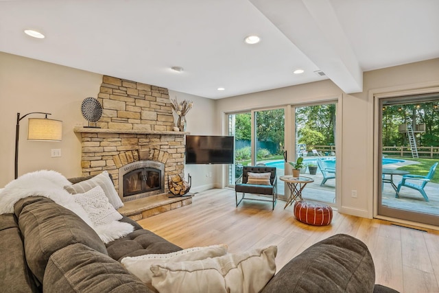 1318 Hickory Ridge Ln, Columbus, OH 43235 - living area featuring wood finished floors, plenty of natural light, a stone fireplace, and recessed lighting