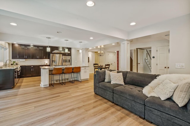 1318 Hickory Ridge Ln, Columbus, OH 43235 - living area with light wood finished floors, stairs, recessed lighting, and decorative columns