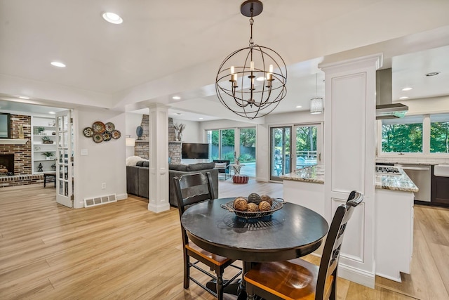 1318 Hickory Ridge Ln, Columbus, OH 43235 - dining area with ornate columns, light wood-type flooring, a brick fireplace, healthy amount of natural light, and recessed lighting