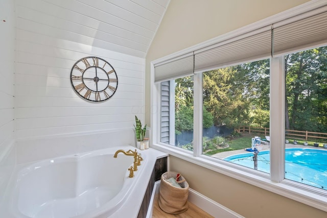 1318 Hickory Ridge Ln, Columbus, OH 43235 - bathroom featuring plenty of natural light, a tub to relax in, and vaulted ceiling