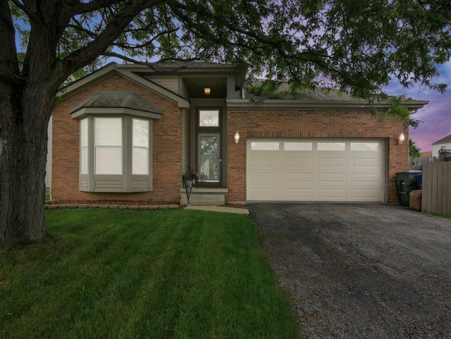 3136 Fabyan Dr, Reynoldsburg, OH 43068 - view of front of house featuring driveway, brick siding, and a garage