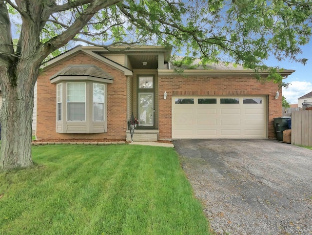 3136 Fabyan Dr, Reynoldsburg, OH 43068 - view of front facade with brick siding, asphalt driveway, and an attached garage