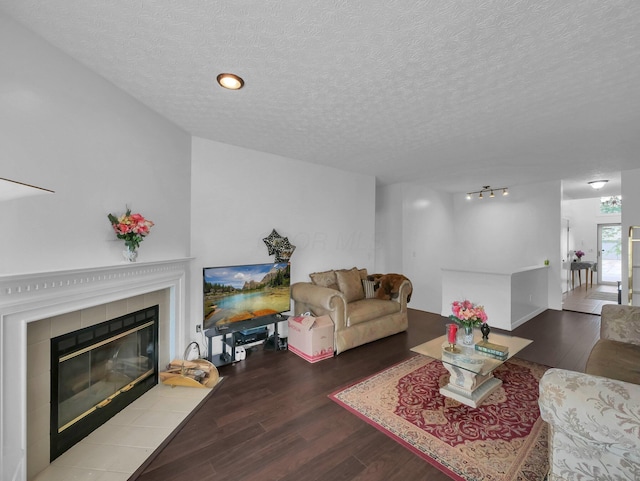 3136 Fabyan Dr, Reynoldsburg, OH 43068 - living area with wood finished floors, a textured ceiling, and a tiled fireplace