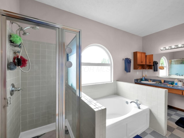 3136 Fabyan Dr, Reynoldsburg, OH 43068 - full bath featuring a stall shower, a garden tub, tile patterned floors, and vanity