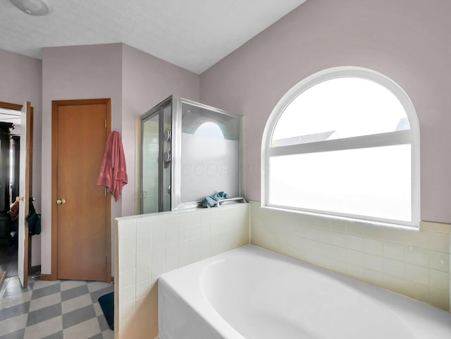 3136 Fabyan Dr, Reynoldsburg, OH 43068 - full bath with a garden tub, tile patterned floors, and a stall shower