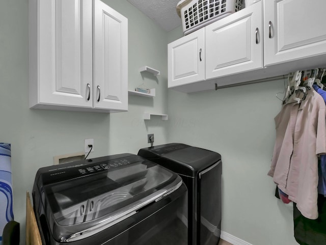 3136 Fabyan Dr, Reynoldsburg, OH 43068 - washroom featuring independent washer and dryer, cabinet space, and a textured ceiling