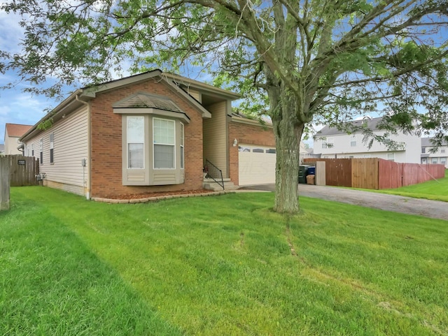 3136 Fabyan Dr, Reynoldsburg, OH 43068 - view of front of home with an attached garage, driveway, and brick siding