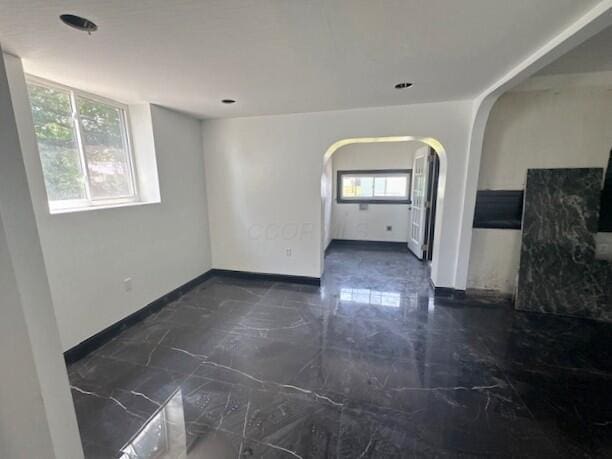 959 Kelton Ave, Columbus, OH 43206 - unfurnished room with arched walkways and dark marble finish floors