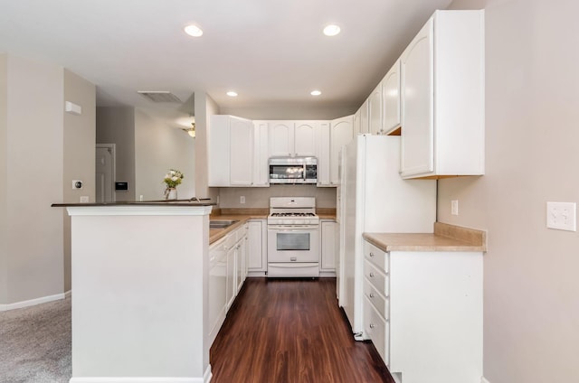 1171 Park Dr, Gahanna, OH 43230 - kitchen with white appliances, white cabinetry, recessed lighting, a peninsula, and dark wood-style floors