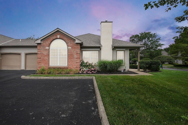 262 Alexander Lawrence Dr, Pickerington, OH 43147 - view of front facade with a chimney, a front lawn, an attached garage, brick siding, and a shingled roof