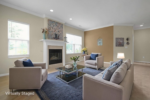 262 Alexander Lawrence Dr, Pickerington, OH 43147 - living room featuring ornamental molding, recessed lighting, a tile fireplace, and wood finished floors