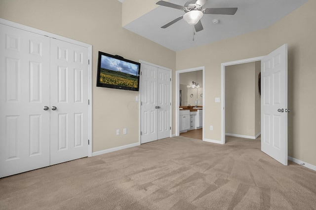 262 Alexander Lawrence Dr, Pickerington, OH 43147 - unfurnished bedroom featuring two closets, light carpet, ensuite bathroom, and a ceiling fan