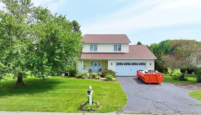 2 Delaware Dr, Fredericktown, OH 43019 - traditional-style house featuring a front yard, driveway, a garage, and a porch