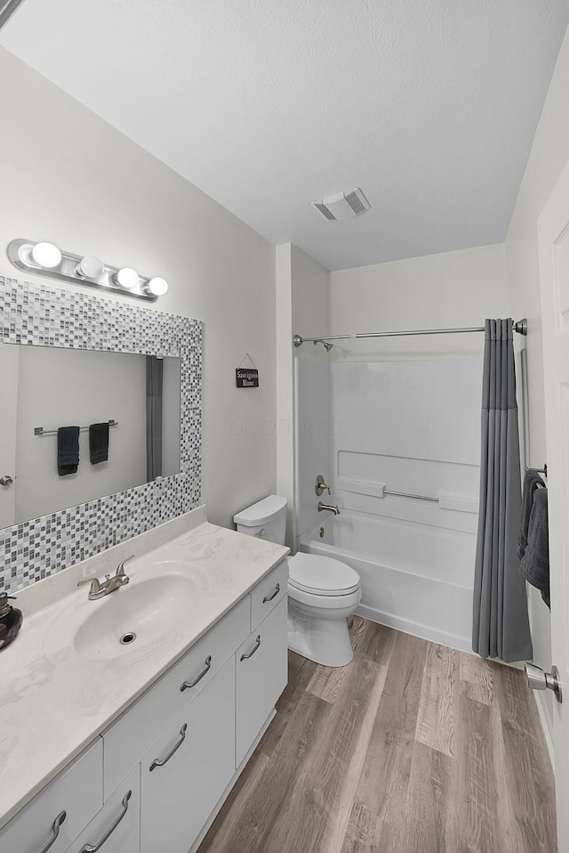 25 Victorian Gate Way, Columbus, OH 43215 - full bathroom with vanity, wood finished floors, shower / bath combo, and a textured ceiling