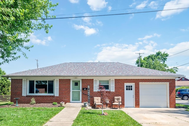 320 W Liberty St, Bucyrus, OH 44820 - view of front of home with an attached garage, brick siding, driveway, and a front yard