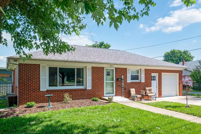 320 W Liberty St, Bucyrus, OH 44820 - single story home with a garage, brick siding, a front yard, concrete driveway, and a shingled roof
