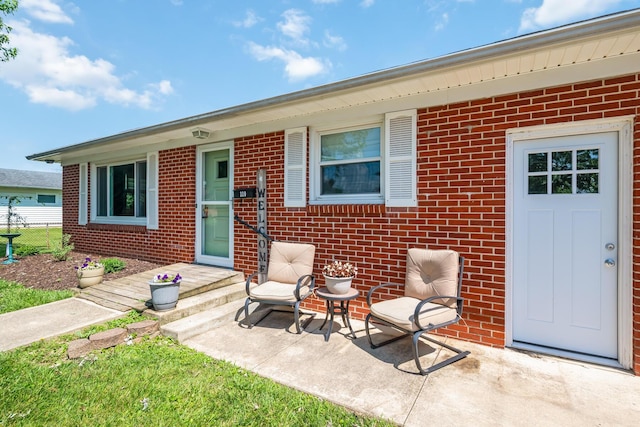 320 W Liberty St, Bucyrus, OH 44820 - doorway to property featuring brick siding and a patio