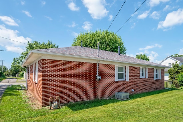 320 W Liberty St, Bucyrus, OH 44820 - view of side of property with brick siding, a lawn, and roof with shingles