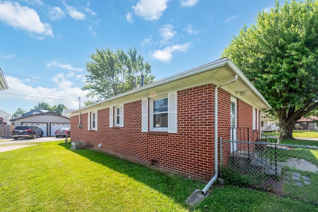 320 W Liberty St, Bucyrus, OH 44820 - view of side of home with brick siding and a detached garage