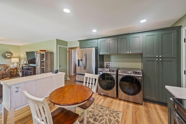 320 W Liberty St, Bucyrus, OH 44820 - kitchen with independent washer and dryer, stainless steel refrigerator with ice dispenser, light wood-type flooring, and recessed lighting